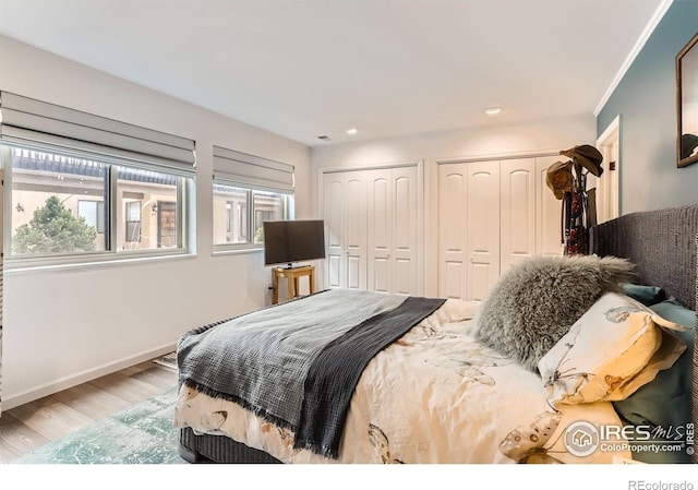 4475 Laguna Pl Unit 206, Boulder, CO 80303 - bedroom featuring two closets, wood finished floors, baseboards, and recessed lighting