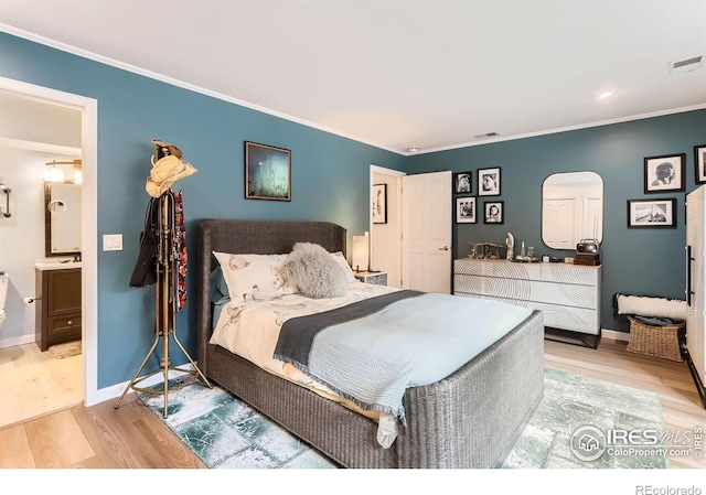 4475 Laguna Pl Unit 206, Boulder, CO 80303 - bedroom with wood finished floors, arched walkways, crown molding, baseboards, and ensuite bathroom