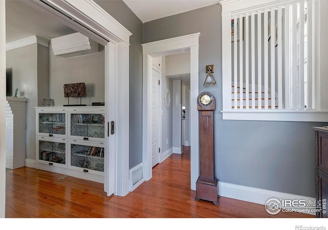 845 14th St, Boulder, CO 80302 - hallway featuring visible vents, baseboards, a wall unit AC, and wood finished floors