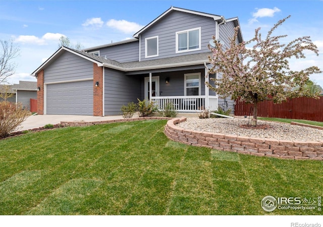 3211 Mammoth Cir, Wellington, CO 80549 - traditional home with a garage, covered porch, concrete driveway, and a front yard
