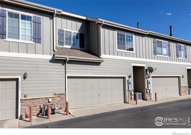 4822 Raven Run, Broomfield, CO 80023 - multi unit property featuring a garage, central AC unit, board and batten siding, and stone siding