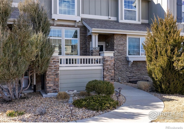 4822 Raven Run, Broomfield, CO 80023 - view of front of home with board and batten siding, roof with shingles, and stone siding
