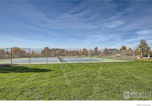 4822 Raven Run, Broomfield, CO 80023 - view of tennis court featuring a lawn and fence
