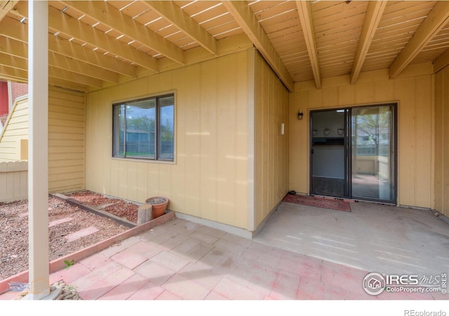 property entrance featuring a patio area and fence