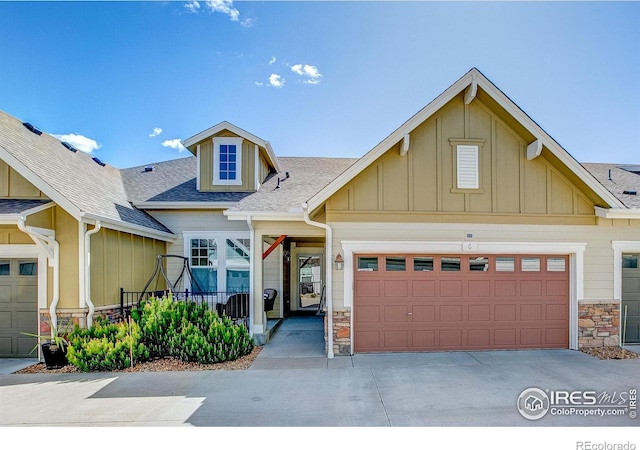 14394 W 88th Dr Unit C, Arvada, CO 80005 - craftsman inspired home featuring stone siding, board and batten siding, concrete driveway, and a shingled roof