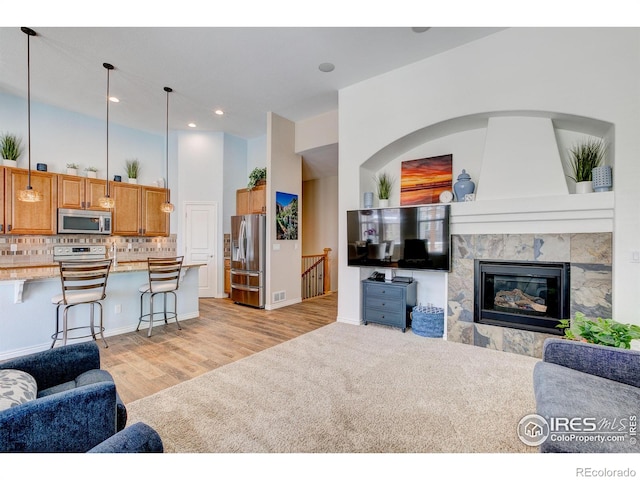 14394 W 88th Dr Unit C, Arvada, CO 80005 - living room with light colored carpet, visible vents, a fireplace, recessed lighting, and light wood-style flooring