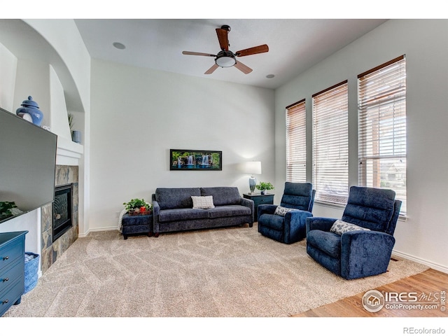 14394 W 88th Dr Unit C, Arvada, CO 80005 - living room featuring baseboards, ceiling fan, a tiled fireplace, and wood finished floors