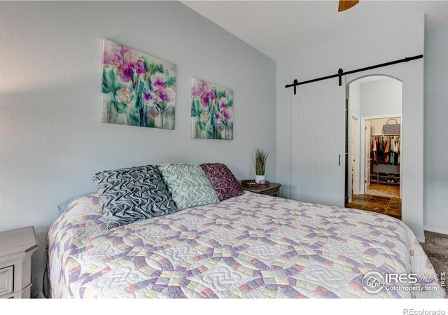 14394 W 88th Dr Unit C, Arvada, CO 80005 - bedroom with carpet floors, a ceiling fan, and a barn door