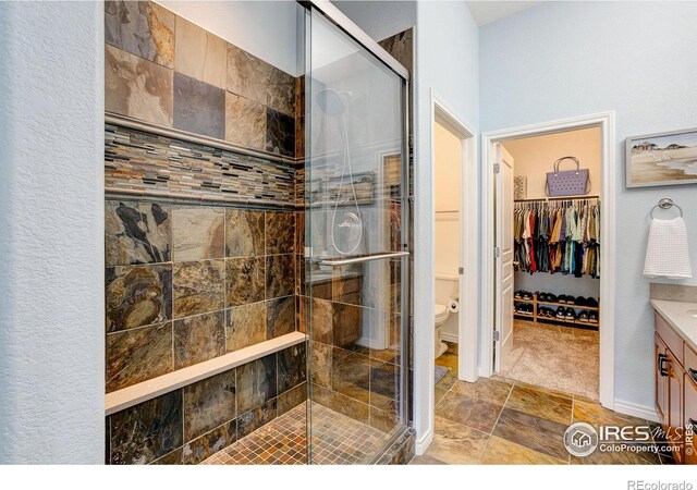 14394 W 88th Dr Unit C, Arvada, CO 80005 - bathroom with vanity, a stall shower, and a spacious closet