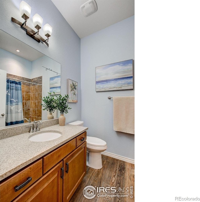14394 W 88th Dr Unit C, Arvada, CO 80005 - bathroom with wood finished floors, vanity, and a tile shower