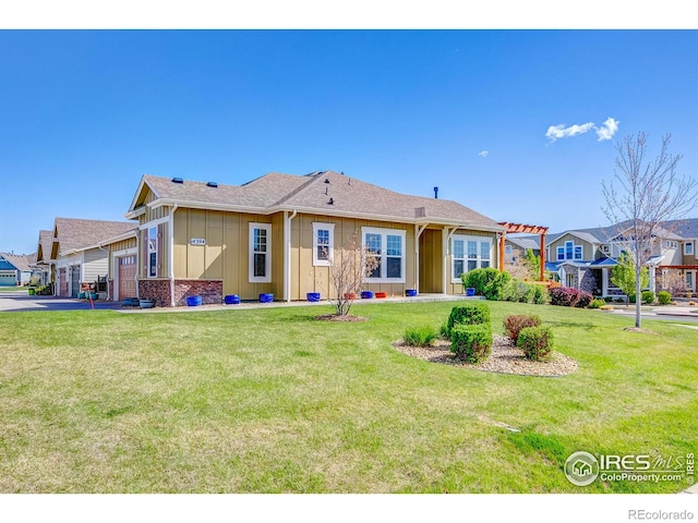 14394 W 88th Dr Unit C, Arvada, CO 80005 - back of house with board and batten siding, a yard, aphalt driveway, and a garage
