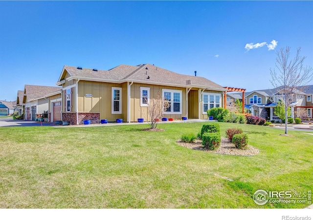 14394 W 88th Dr Unit C, Arvada, CO 80005 - rear view of property with a garage, board and batten siding, a lawn, and driveway