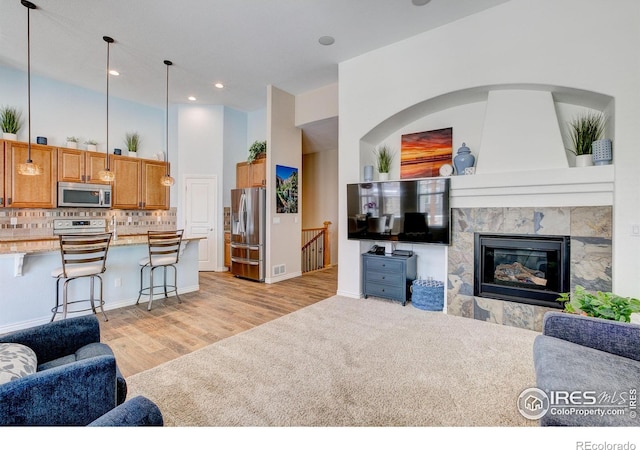 14394 W 88th Dr Unit C, Arvada, CO 80005 - living area featuring light wood-type flooring, recessed lighting, and a high end fireplace
