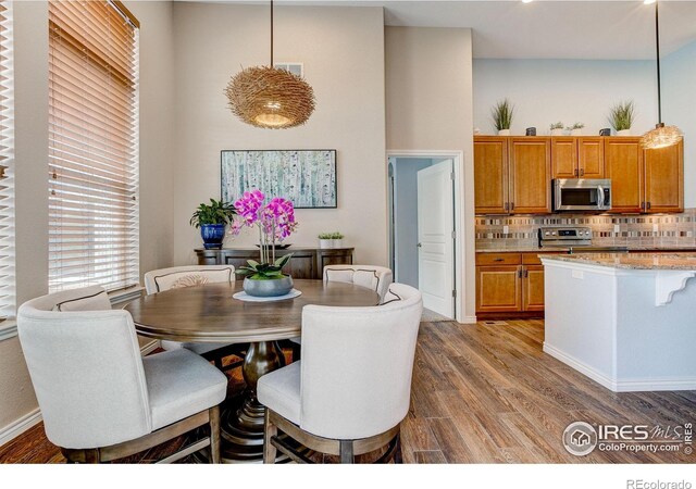 14394 W 88th Dr Unit C, Arvada, CO 80005 - dining space featuring wood finished floors and a high ceiling