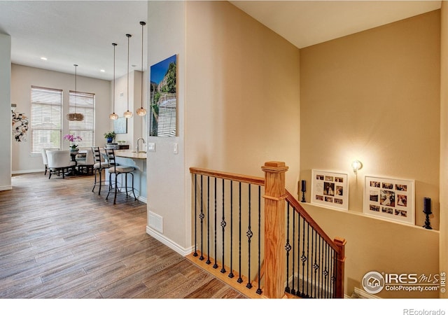 14394 W 88th Dr Unit C, Arvada, CO 80005 - hallway featuring wood finished floors, an upstairs landing, and recessed lighting