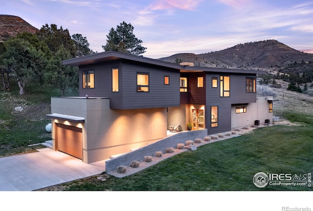 451 Red Gulch Rd, Lyons, CO 80540 - view of front of property featuring a lawn, a mountain view, concrete driveway, and a garage