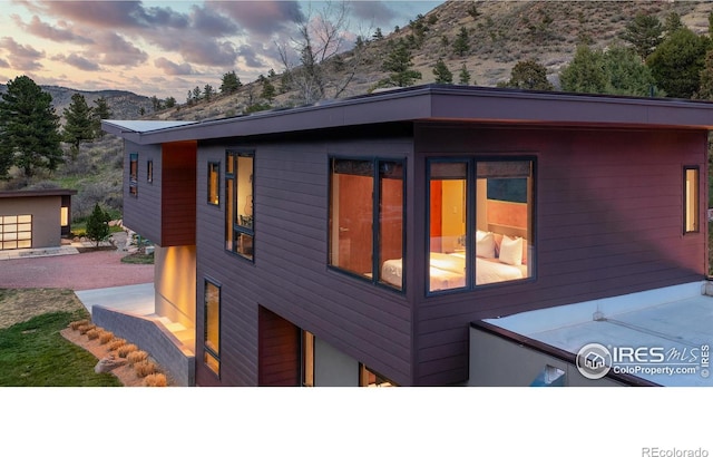 451 Red Gulch Rd, Lyons, CO 80540 - property exterior at dusk with a mountain view