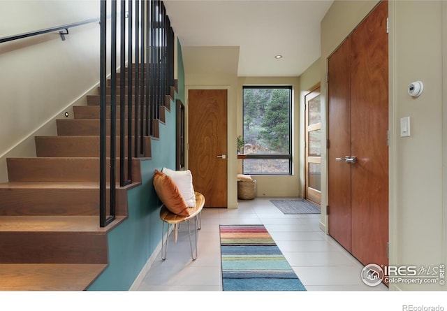 451 Red Gulch Rd, Lyons, CO 80540 - doorway featuring baseboards, recessed lighting, tile patterned floors, and stairway