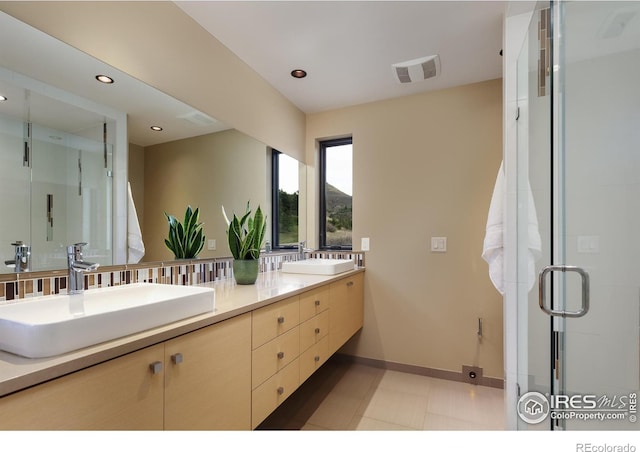 451 Red Gulch Rd, Lyons, CO 80540 - full bathroom with double vanity, baseboards, visible vents, and a sink