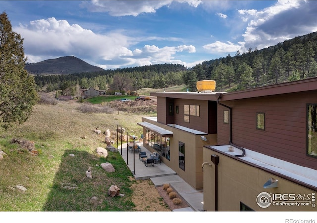 451 Red Gulch Rd, Lyons, CO 80540 - exterior space featuring a view of trees, a patio area, and a mountain view