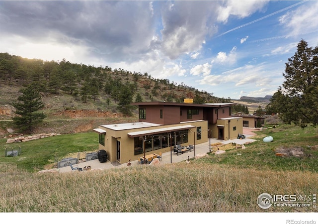 451 Red Gulch Rd, Lyons, CO 80540 - back of house with a patio, a mountain view, and stucco siding