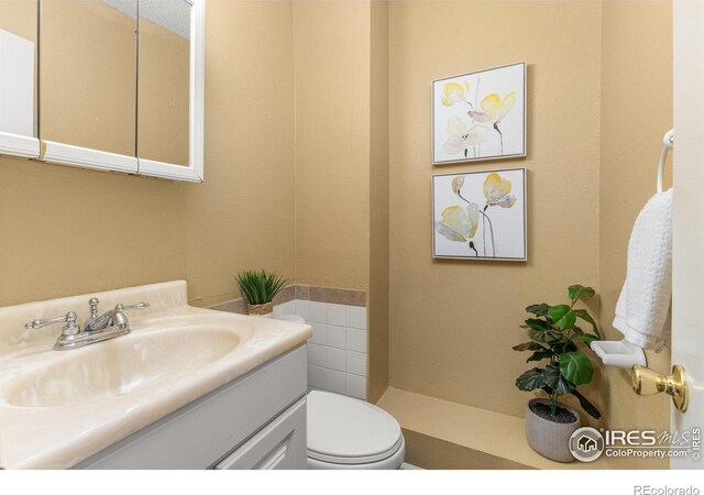 bathroom featuring vanity and toilet