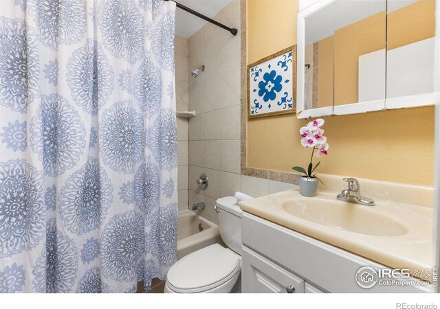 bathroom with vanity, toilet, and shower / tub combo with curtain