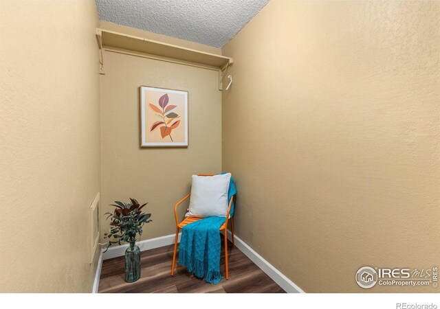 living area featuring baseboards and wood finished floors