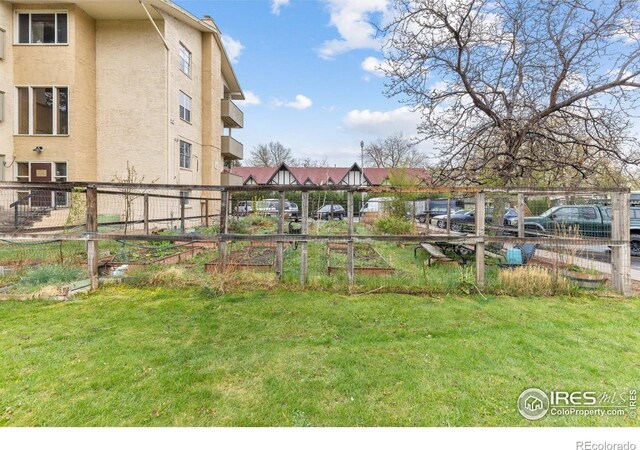 view of yard with fence and a vegetable garden