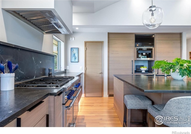 50 Wildwood Ln, Boulder, CO 80304 - kitchen with double oven range, extractor fan, modern cabinets, light wood-style floors, and pendant lighting