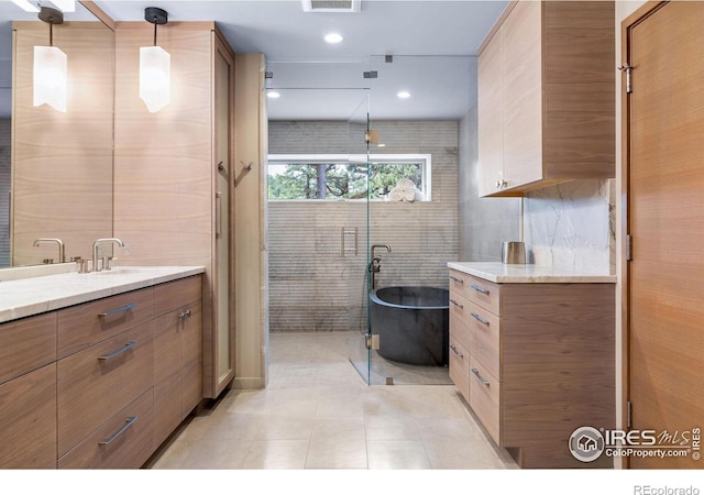50 Wildwood Ln, Boulder, CO 80304 - bathroom with vanity, tile walls, a freestanding tub, and tile patterned floors
