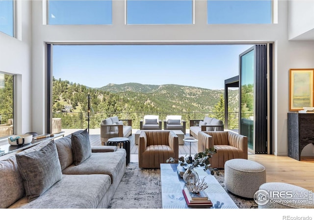 50 Wildwood Ln, Boulder, CO 80304 - living area with a mountain view, a towering ceiling, wood finished floors, and plenty of natural light