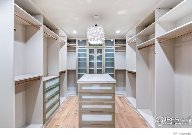 50 Wildwood Ln, Boulder, CO 80304 - walk in closet featuring light wood-type flooring and a chandelier