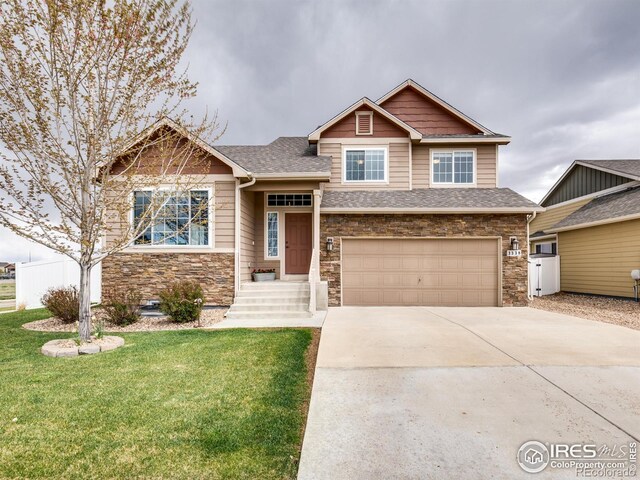 3338 Auklet Dr, Berthoud, CO 80513 - craftsman house featuring a shingled roof, an attached garage, stone siding, a front yard, and concrete driveway