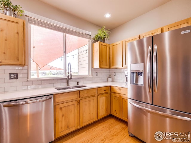 3338 Auklet Dr, Berthoud, CO 80513 - kitchen featuring light countertops, appliances with stainless steel finishes, a sink, and tasteful backsplash