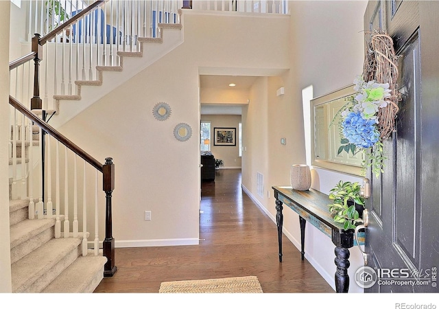 2927 Percheron Dr, Fort Collins, CO 80525 - entryway featuring visible vents, stairs, wood finished floors, baseboards, and a high ceiling