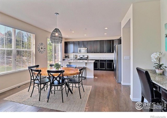2927 Percheron Dr, Fort Collins, CO 80525 - dining room featuring baseboards, recessed lighting, dark wood finished floors, and visible vents