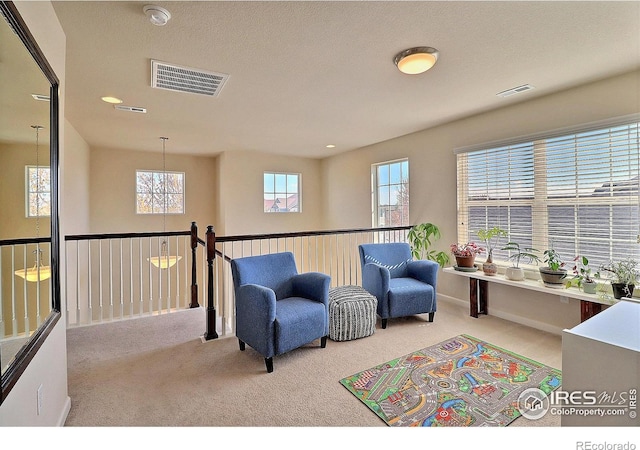 2927 Percheron Dr, Fort Collins, CO 80525 - living area featuring visible vents, carpet, and a notable chandelier