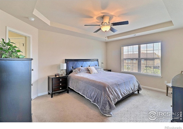 2927 Percheron Dr, Fort Collins, CO 80525 - bedroom featuring light colored carpet, baseboards, ceiling fan, and a tray ceiling