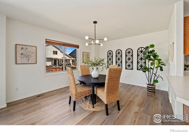 1532 Corydalis Ct, Fort Collins, CO 80526 - dining room with wood finished floors, a chandelier, and baseboards