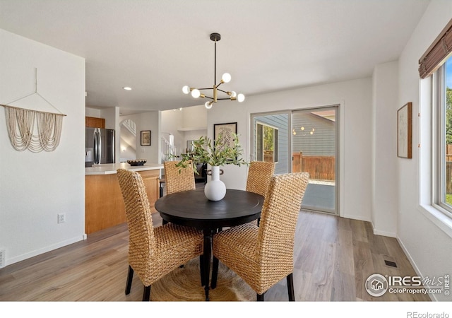 1532 Corydalis Ct, Fort Collins, CO 80526 - dining room with light wood finished floors, a chandelier, and baseboards