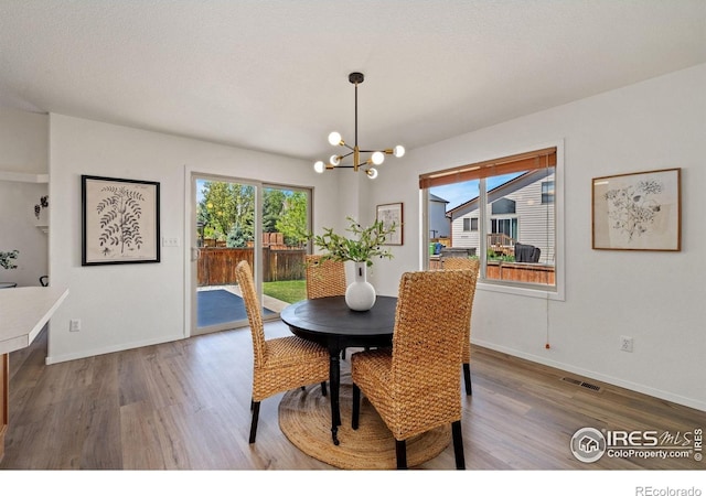 1532 Corydalis Ct, Fort Collins, CO 80526 - dining room with a chandelier, wood finished floors, and baseboards