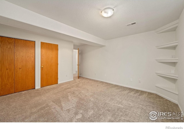 1532 Corydalis Ct, Fort Collins, CO 80526 - unfurnished bedroom with carpet, a textured ceiling, two closets, and baseboards