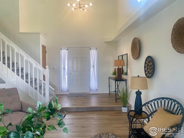 1532 Corydalis Ct, Fort Collins, CO 80526 - foyer entrance featuring stairway, wood finished floors, a towering ceiling, a chandelier, and baseboards