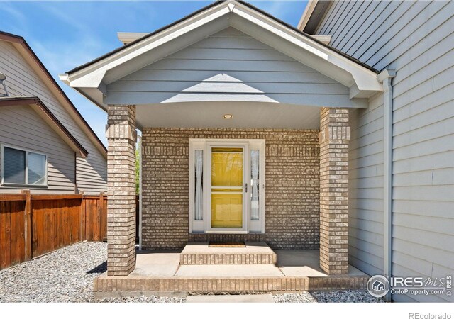 1532 Corydalis Ct, Fort Collins, CO 80526 - property entrance with fence and brick siding