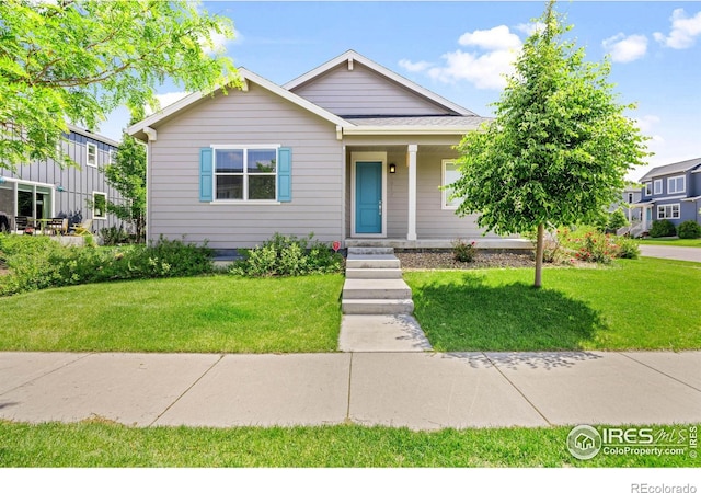 4672 Clear Creek Dr, Longmont, CO 80504 - view of front of house featuring a porch and a front lawn
