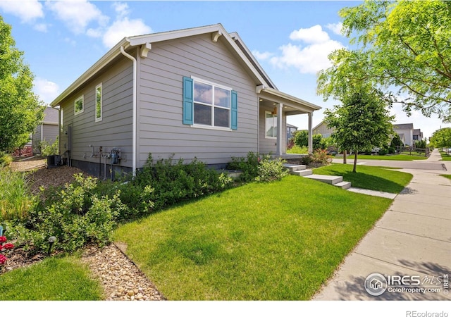 4672 Clear Creek Dr, Longmont, CO 80504 - view of front of home with a front yard, covered porch, and central air condition unit