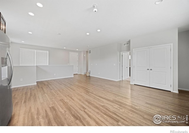4672 Clear Creek Dr, Longmont, CO 80504 - unfurnished living room with light wood-type flooring, recessed lighting, and baseboards