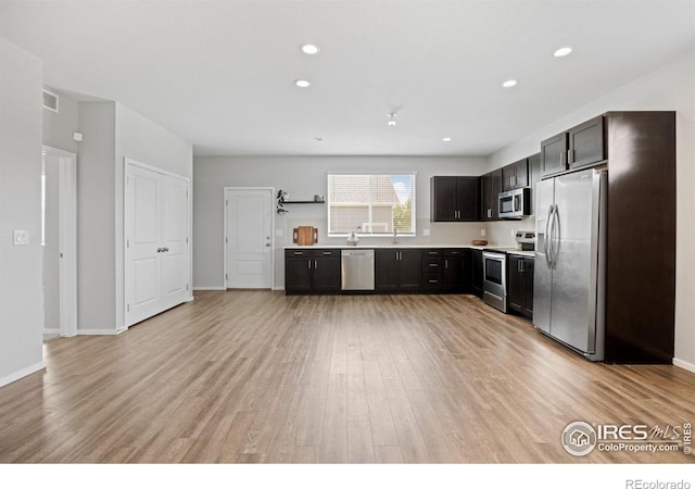 4672 Clear Creek Dr, Longmont, CO 80504 - kitchen with appliances with stainless steel finishes, light wood finished floors, light countertops, recessed lighting, and a sink