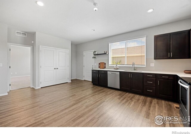 4672 Clear Creek Dr, Longmont, CO 80504 - kitchen with stainless steel appliances, a sink, light wood-style floors, light countertops, and recessed lighting